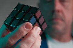 man holding cube