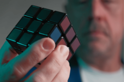 man holding cube