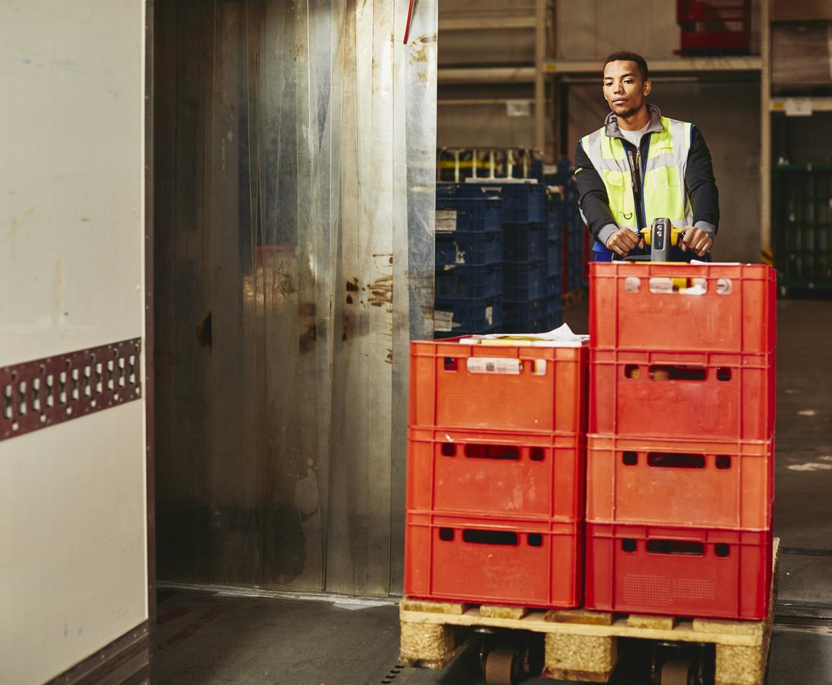 Man unloading crates from truck